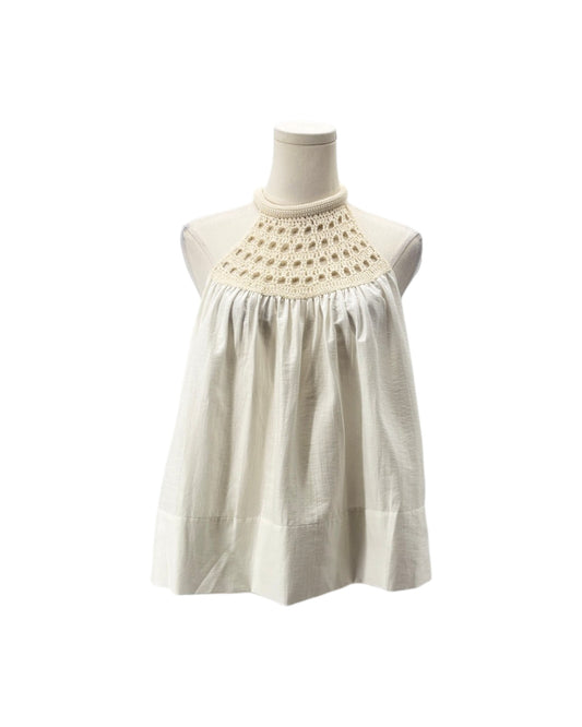 An off-white sleeveless top with a decorative crocheted yoke, displayed on a mannequin torso against a plain white background.