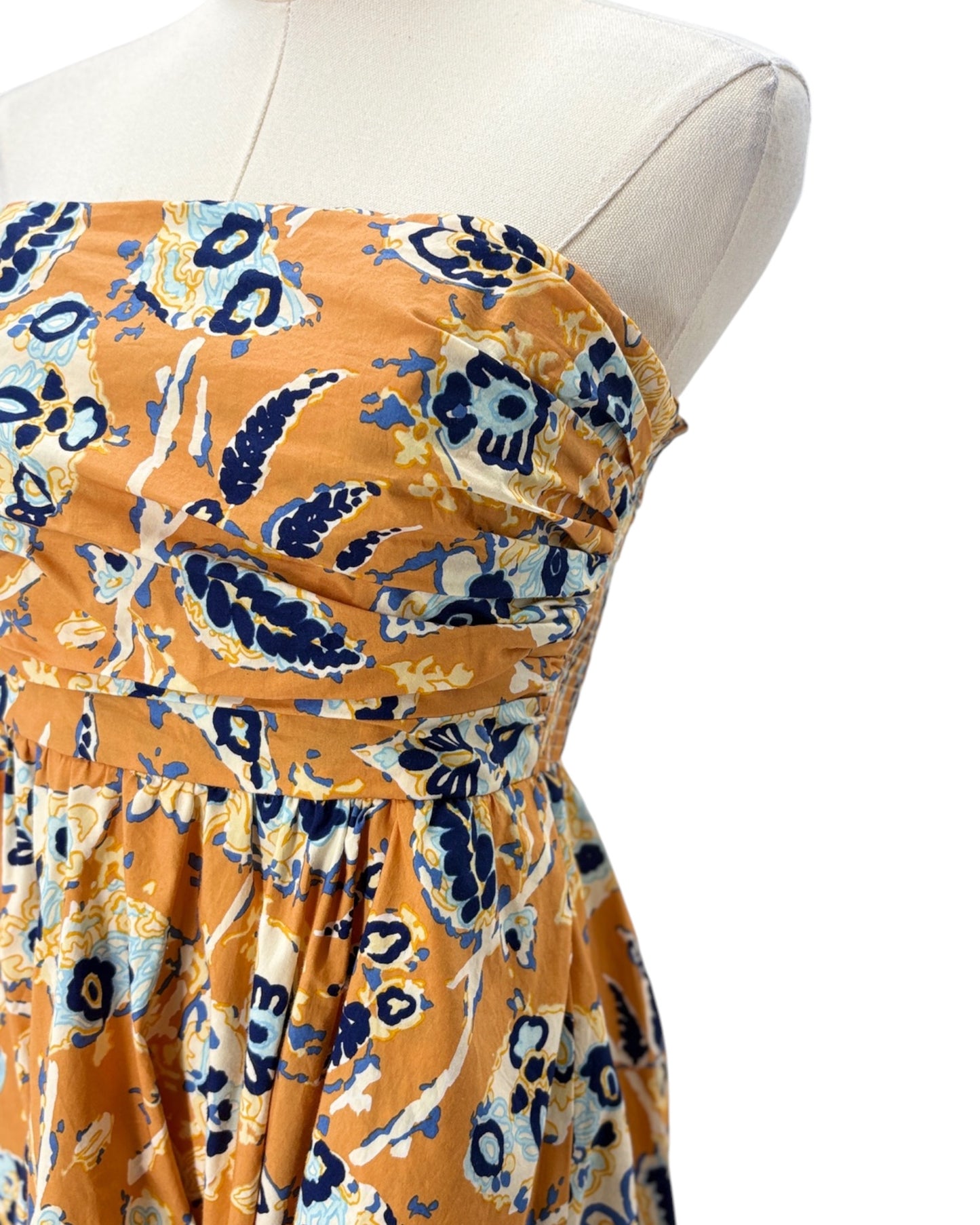 Floral dress on a mannequin against a white background