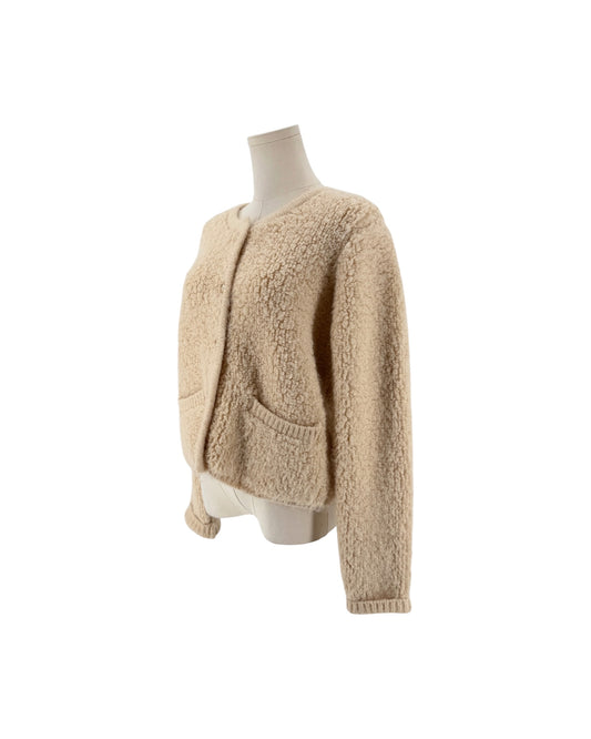 Beige Shaggy loop knit fabric, classic crewneck neckline, metallic button front closure, ribbed trim along the hem and cuffs, two front welt pockets cardigan on white background on a mannequin