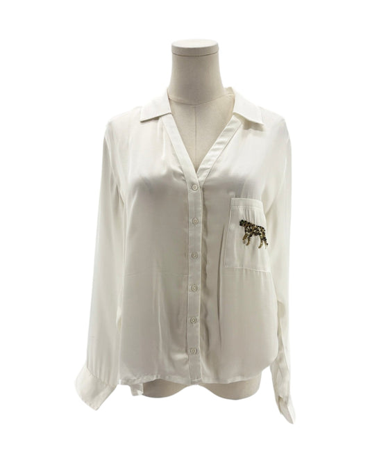 White shirt with a pocket and decorative element on a mannequin against a white background