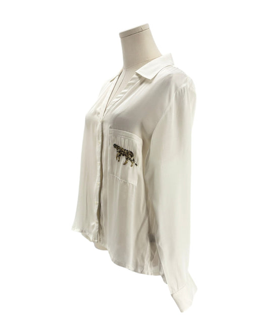White shirt with a pocket design on a mannequin against a white background