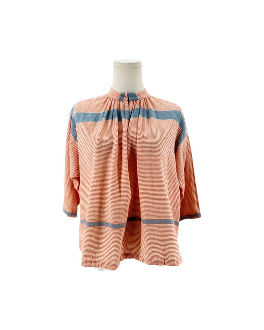 A peach-colored long-sleeve blouse with blue horizontal stripes, displayed on a mannequin torso against a white background.