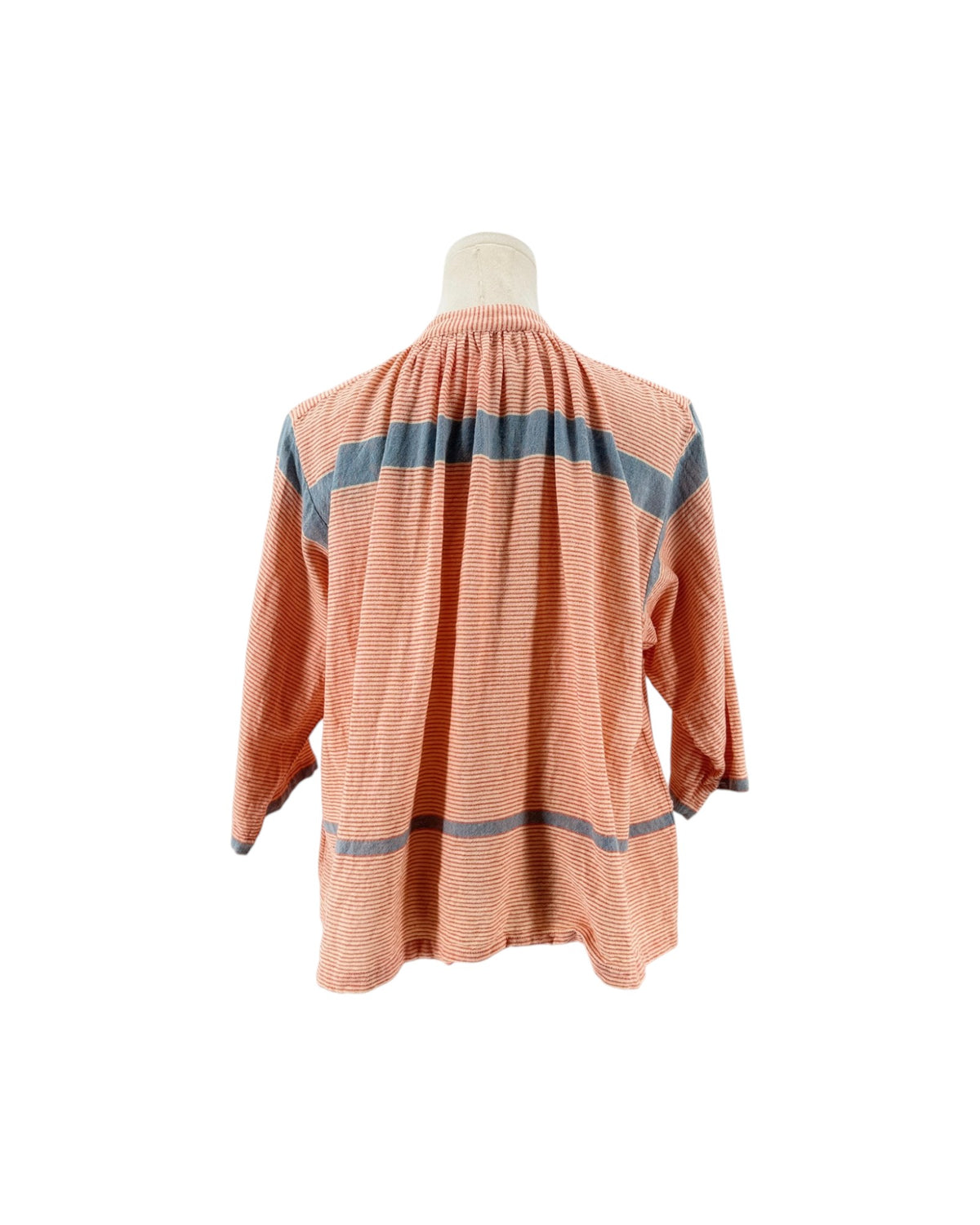 A peach-colored long-sleeve blouse with blue horizontal stripes, displayed on a mannequin torso against a white background.