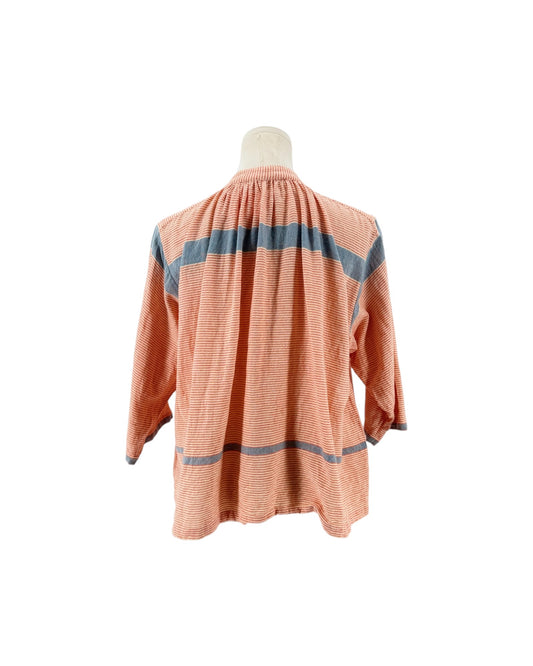 A peach-colored long-sleeve blouse with blue horizontal stripes, displayed on a mannequin torso against a white background.