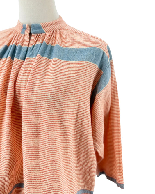 A peach-colored long-sleeve blouse with blue horizontal stripes, displayed on a mannequin torso against a white background.