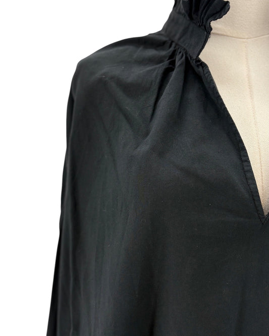 Black blouse on a mannequin with a white background