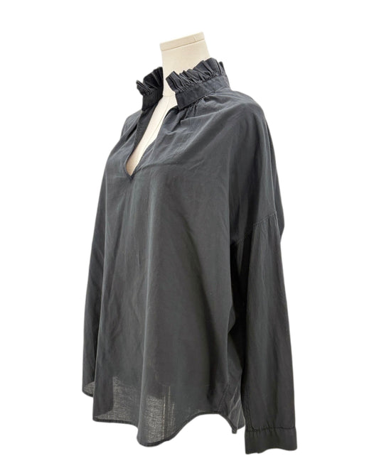 Black blouse on a mannequin against a white background