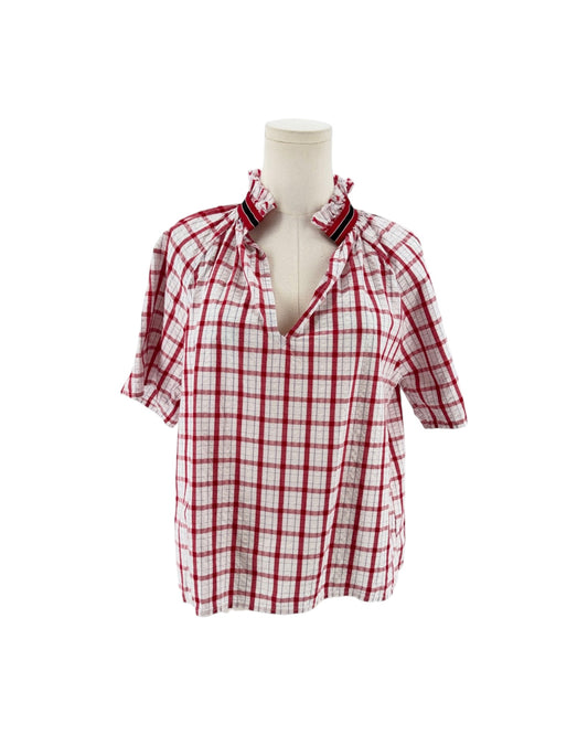 Red and white checkered with metallic threads short sleeve, side slits, split v-neckline, high ruffled collar trimmed with contrasting multi-colored striped ribbon on a mannequin on a white background