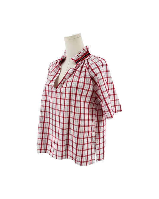 Red and white checkered with metallic threads short sleeve, side slits, split v-neckline, high ruffled collar trimmed with contrasting multi-colored striped ribbon on a mannequin on a white background