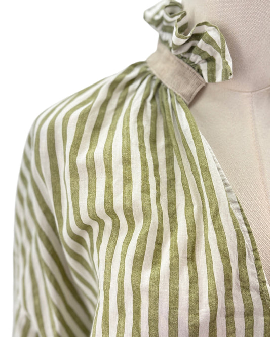Green and white striped dress on a mannequin with a plain background