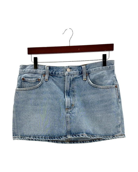 Blue denim skirt on a hanger against a white background