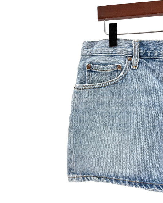 Light blue denim skirt on a hanger against a white background