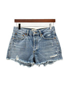 Denim shorts on a hanger with a white background