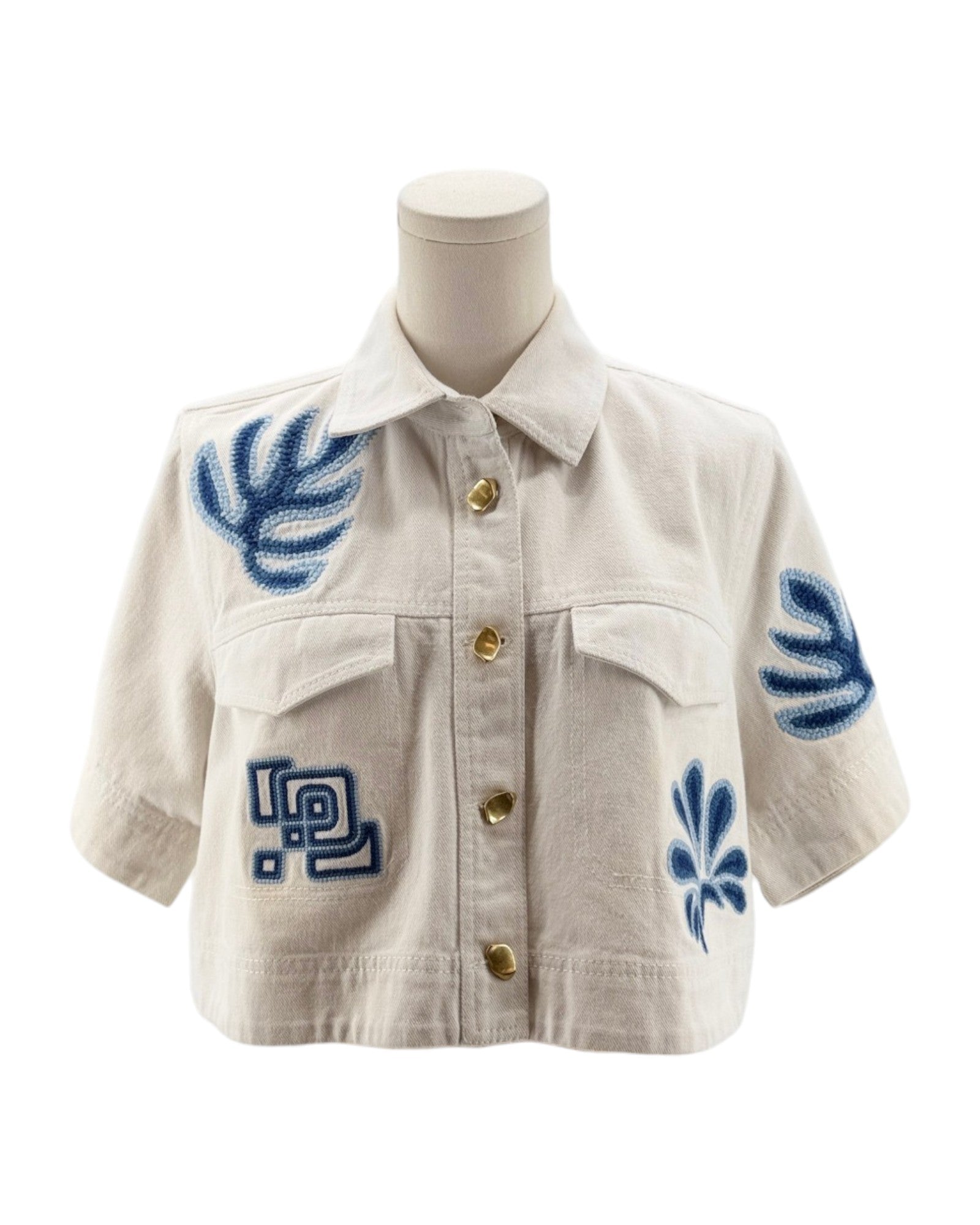 White jacket with blue floral patterns on a mannequin against a white background
