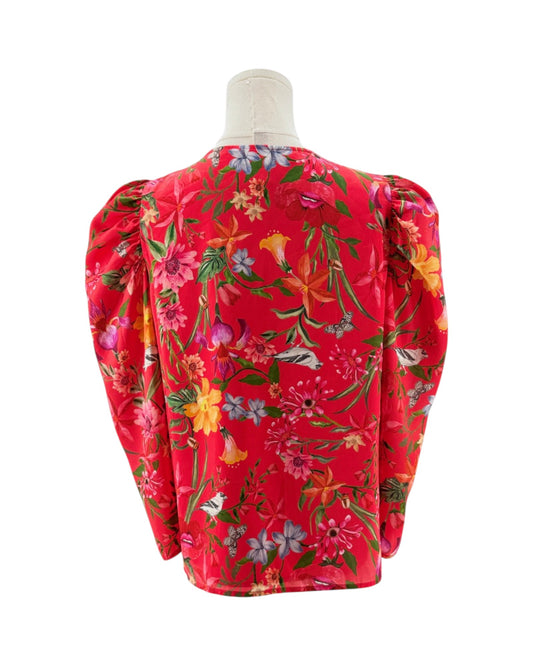 Red floral blouse on a mannequin with a white background