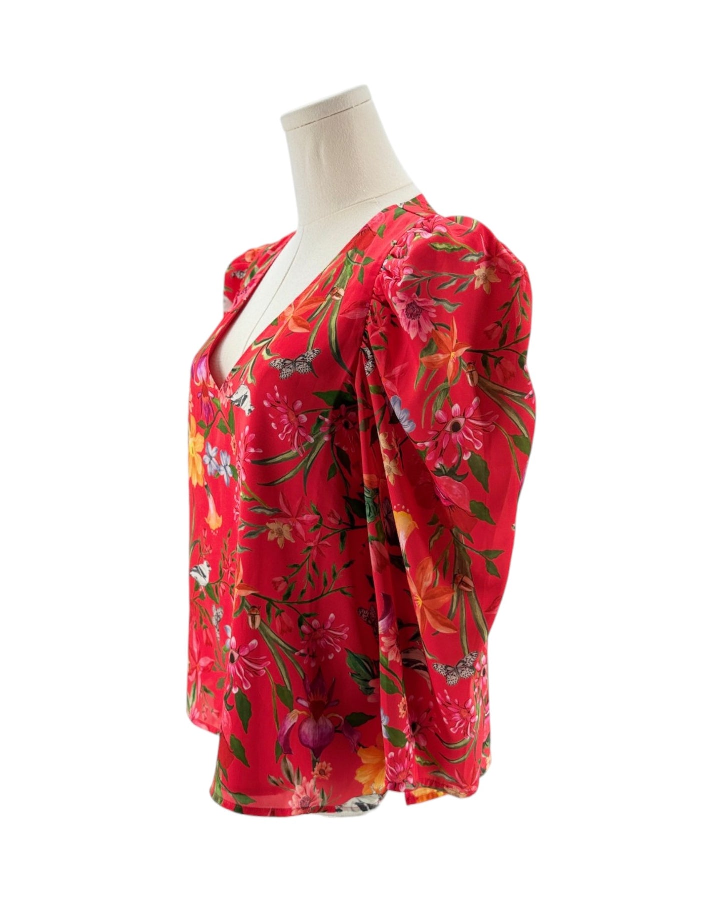 Red floral dress on a mannequin against a white background