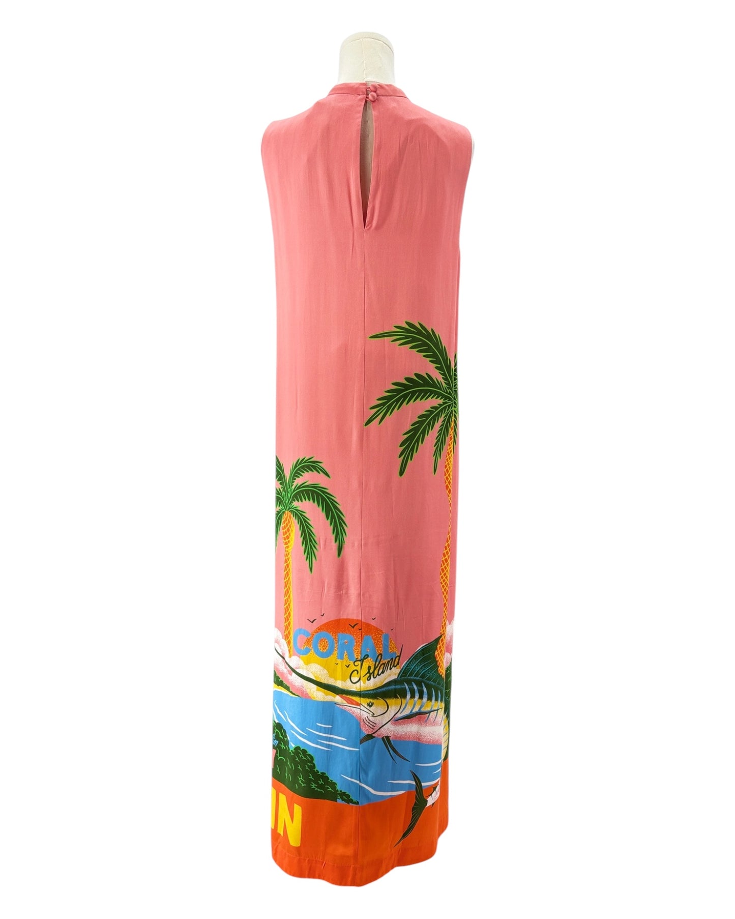 Sleeveless silk dress with tropical design on a mannequin against a white background