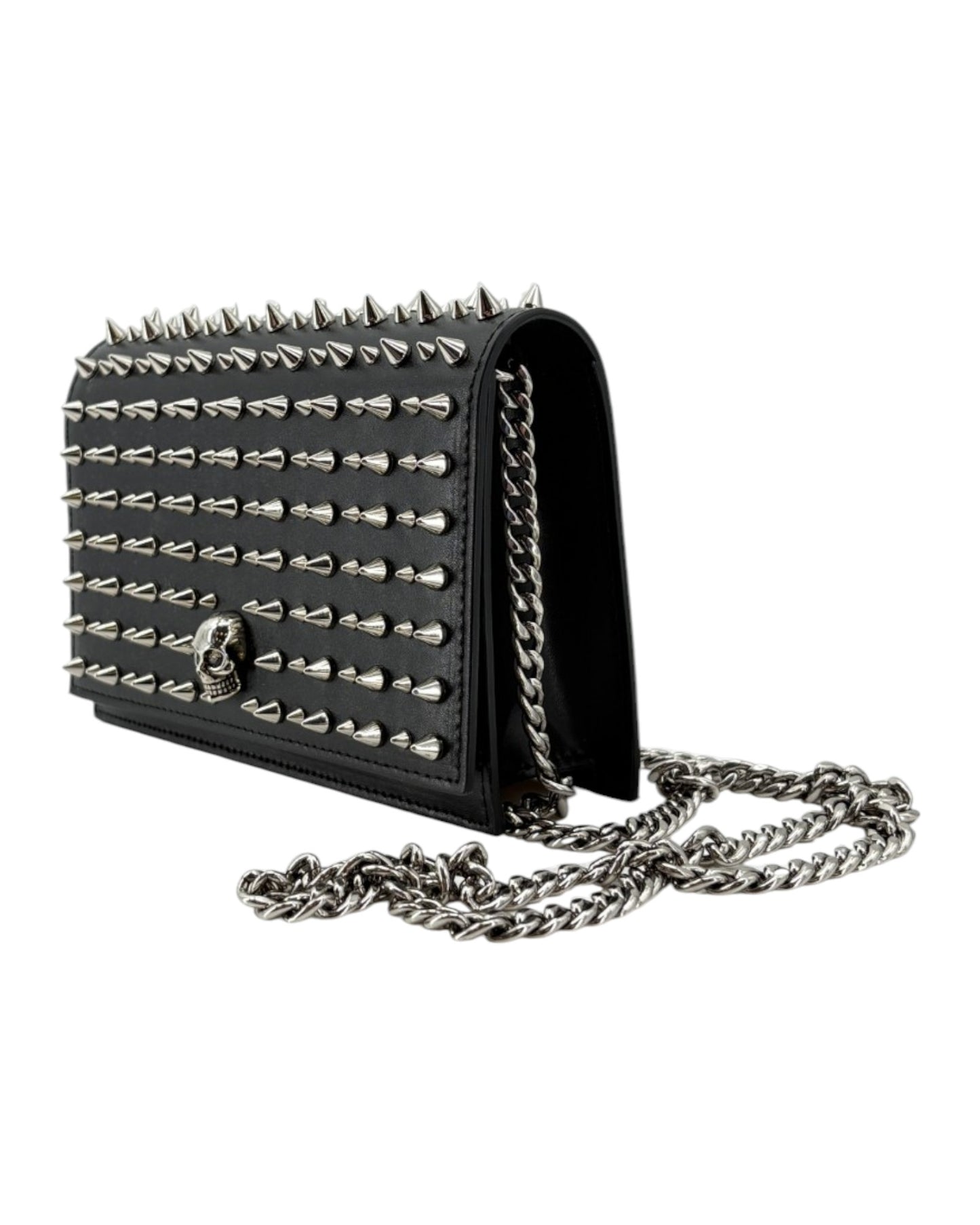 Black studded handbag with chain strap on a white background