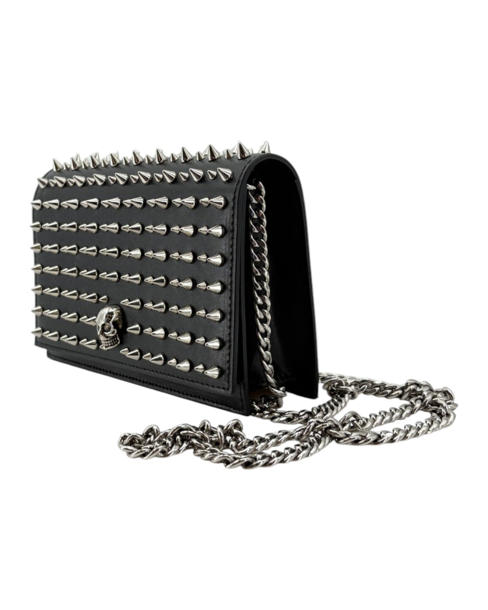 Black studded handbag with chain strap on a white background