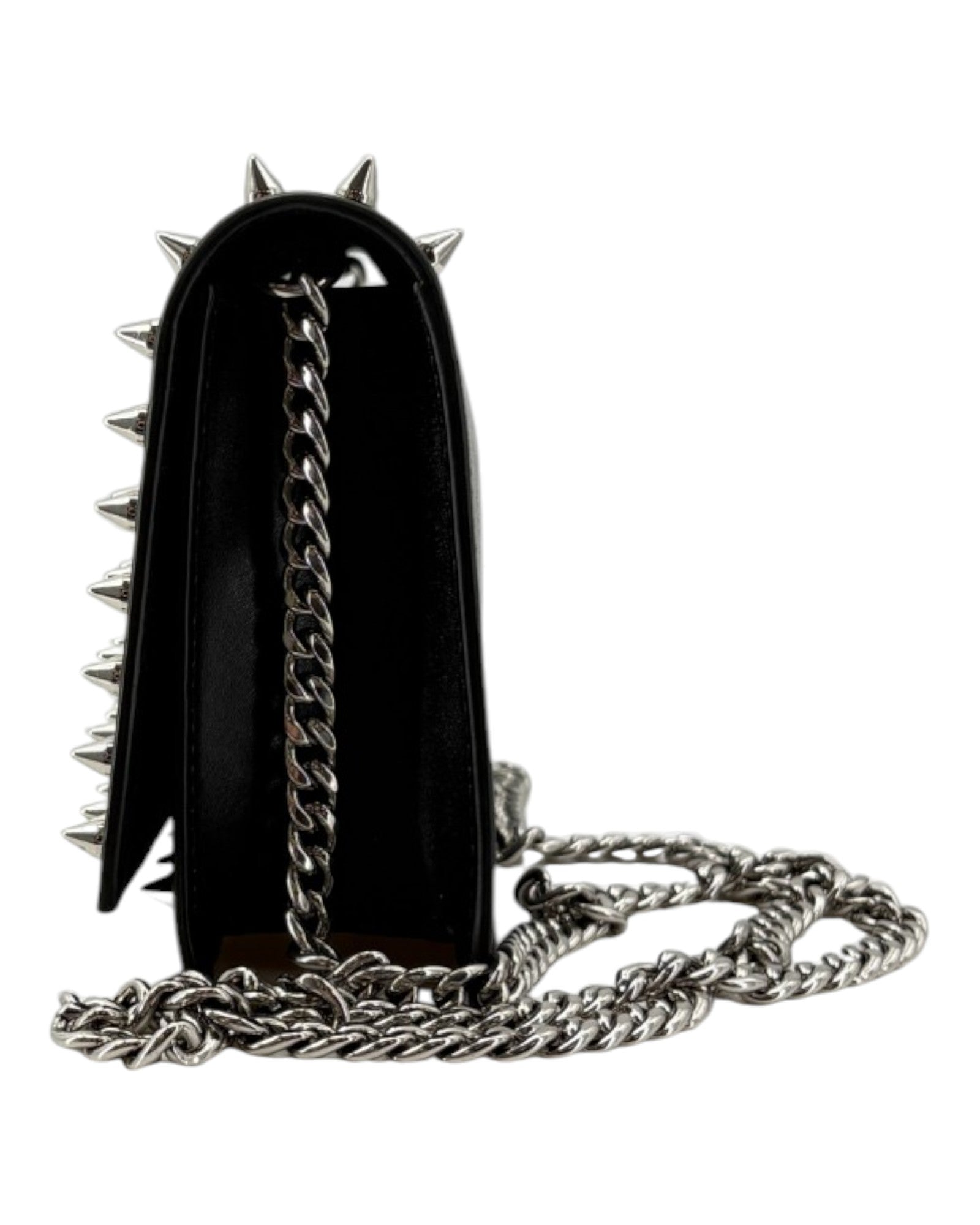 Black handbag with silver spikes and chain strap on a white background