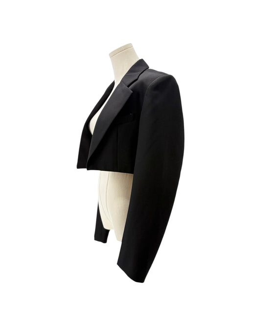 A black cropped blazer jacket displayed on a cream-colored mannequin torso against a solid white background.