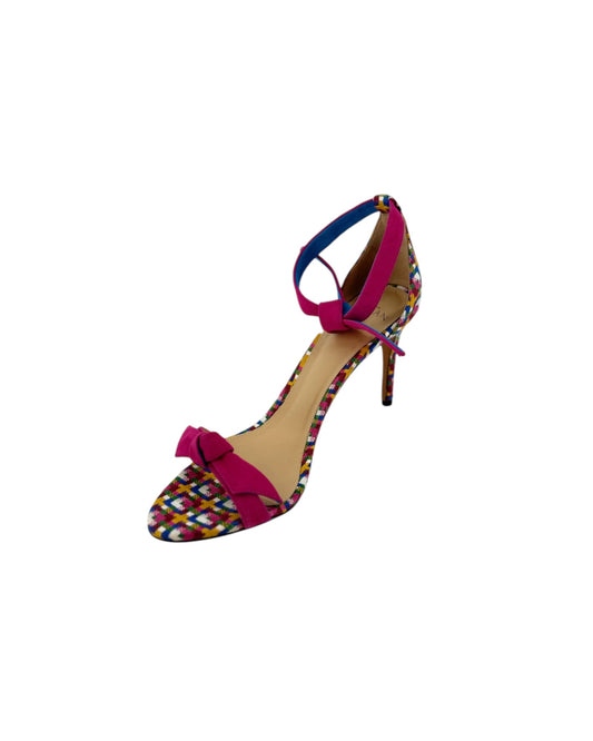 High heels with a multi color geometric print with a pink ankle and toe strap on white background