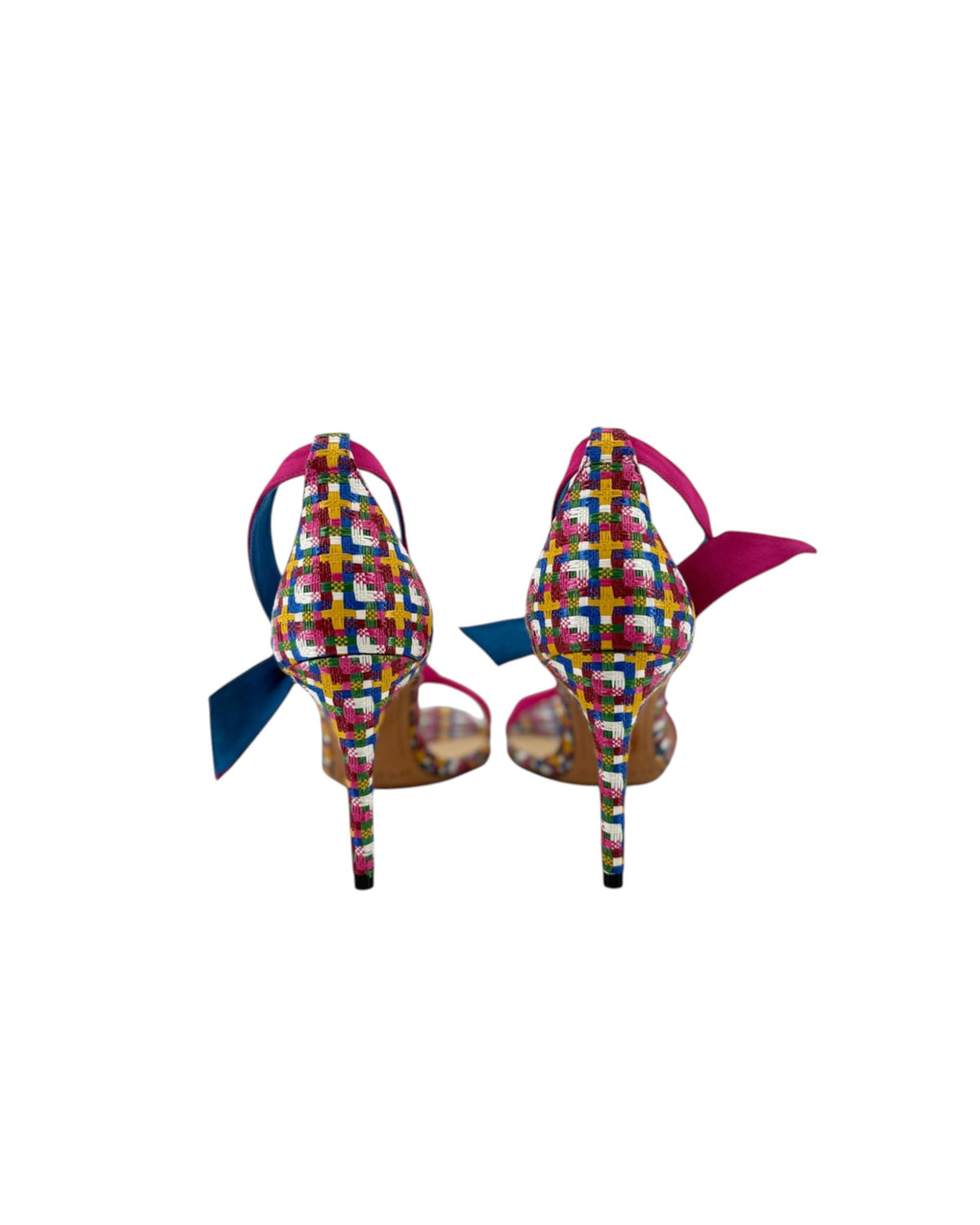 High heels with a multi color geometric print with a pink ankle and toe strap on white background