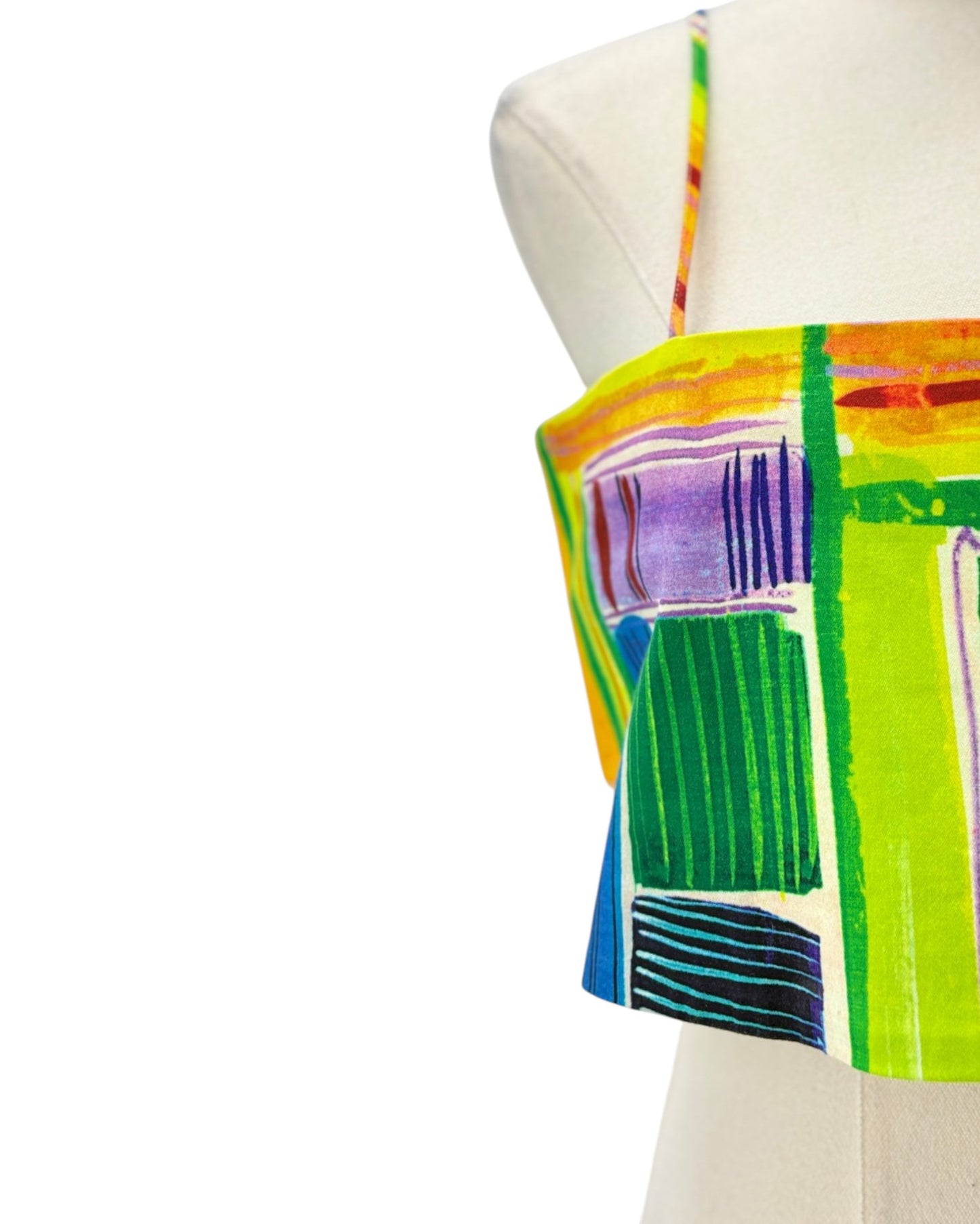 Colorful abstract-patterned top on a mannequin against a white background
