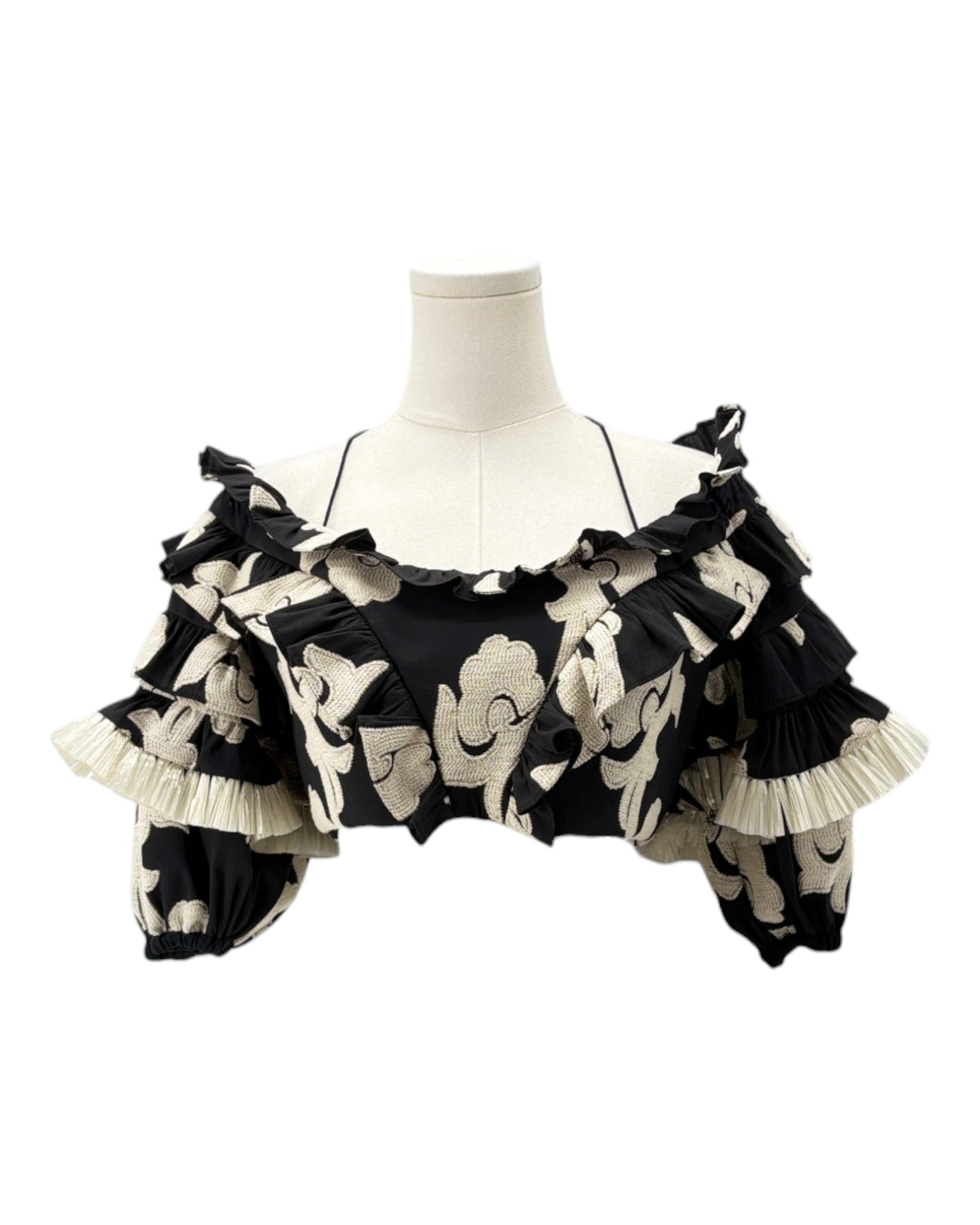 Black and white floral patterned top on a mannequin against a white background