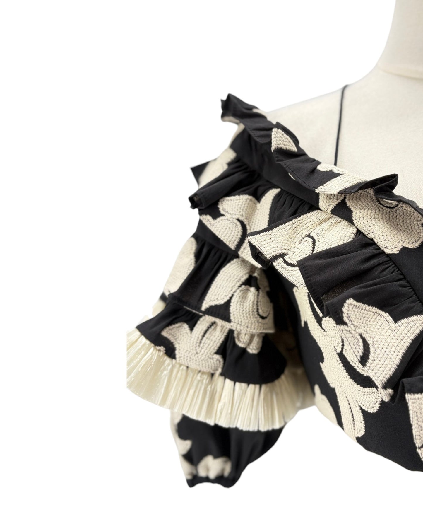 Black and white patterned dress on a mannequin against a white background