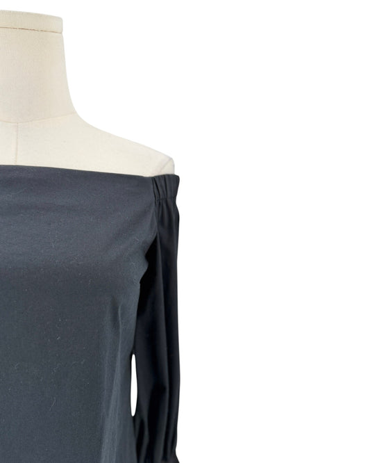 A close-up of an off-the-shoulder long-sleeve top in a dark slate gray color, displayed on a cream-colored mannequin torso against a plain white background.