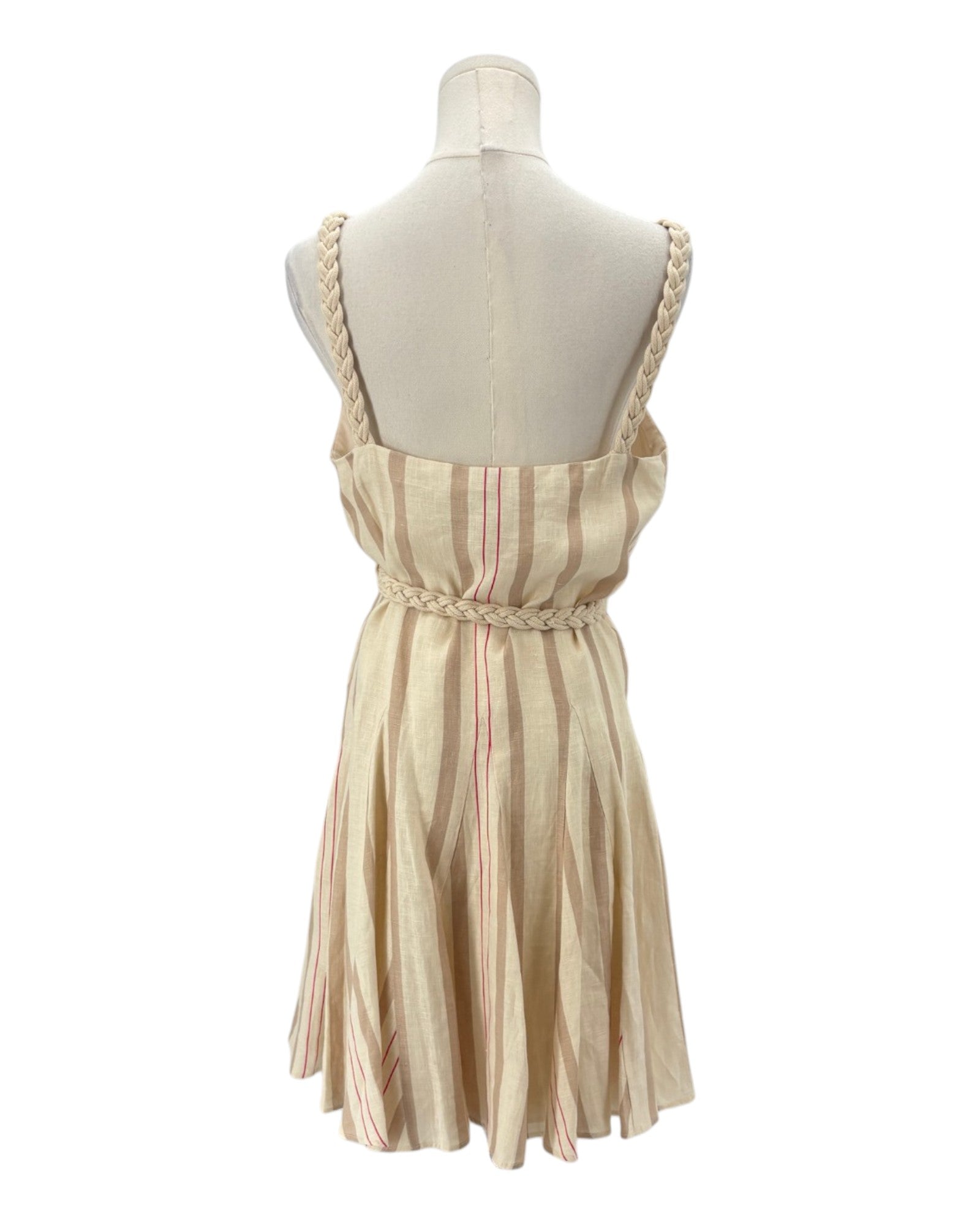 Beige and pink striped dress on a mannequin against a white background
