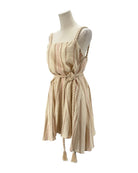 Beige and pink striped dress on a mannequin against a white background