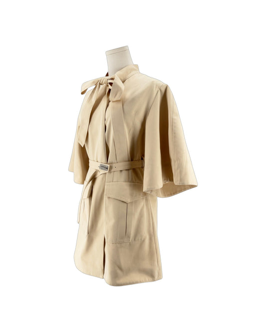 3/4 length beige mini dress with a oversized bowtie neckline and a matching belt with silver hardware on a white background on a mannequin
