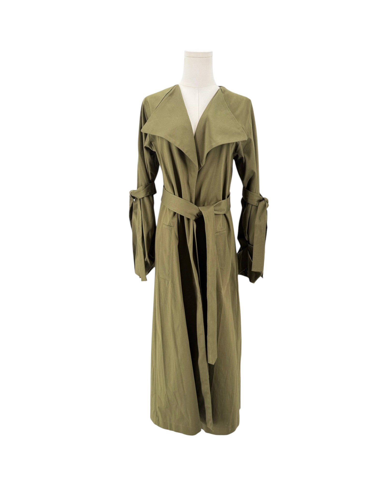 An olive green long trench coat with a matching waist tie belt, displayed on a headless mannequin against a plain white background.