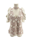 Lace v neck short sleeve blouse on a mannequin on a white background