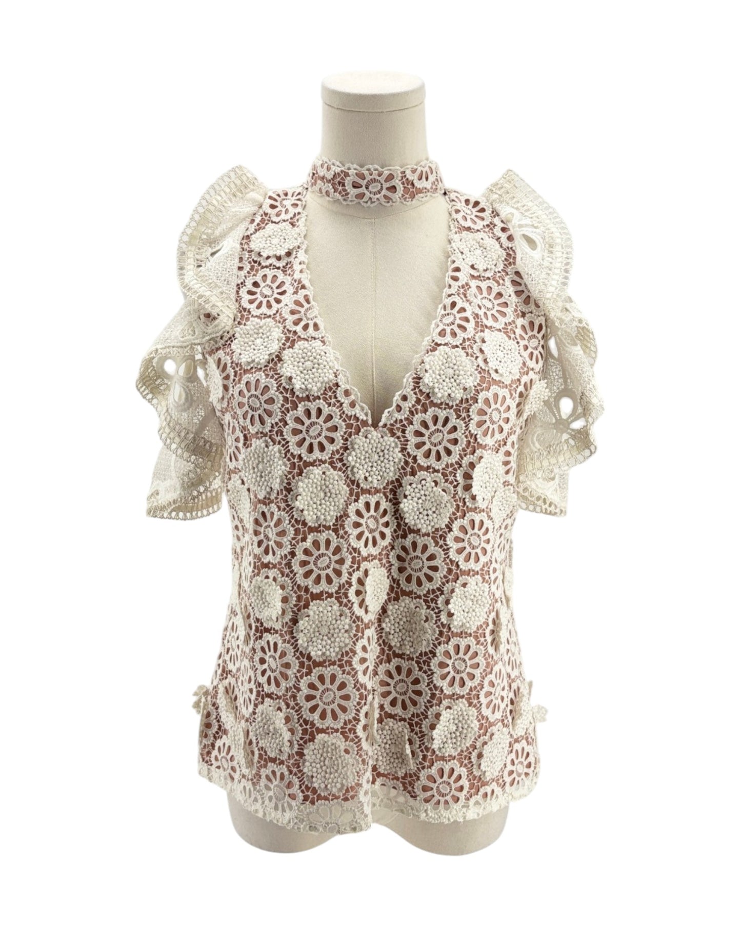 Lace v neck short sleeve blouse on a mannequin on a white background