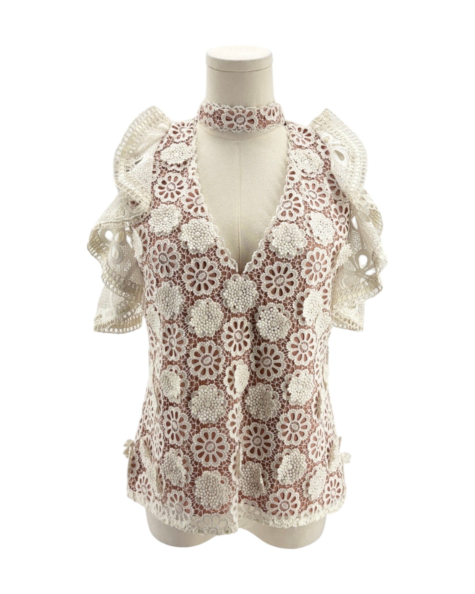 Lace v neck short sleeve blouse on a mannequin on a white background