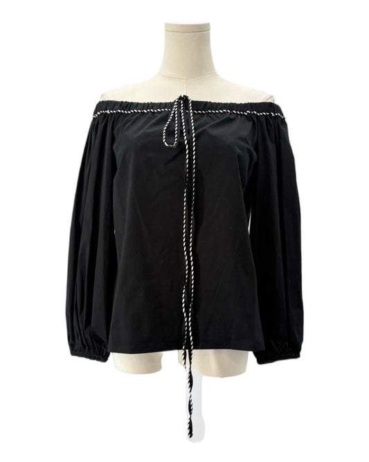 Black off-shoulder blouse with white trim on a mannequin against a white background