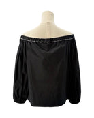 Black off-shoulder blouse on a mannequin with a white background