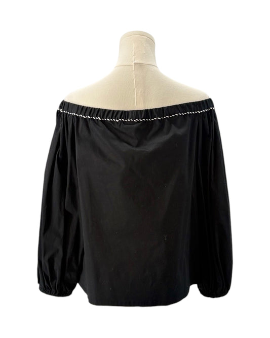 Black off-shoulder blouse on a mannequin with a white background