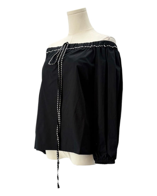 Black off-shoulder top with pearl details on a mannequin against a white background