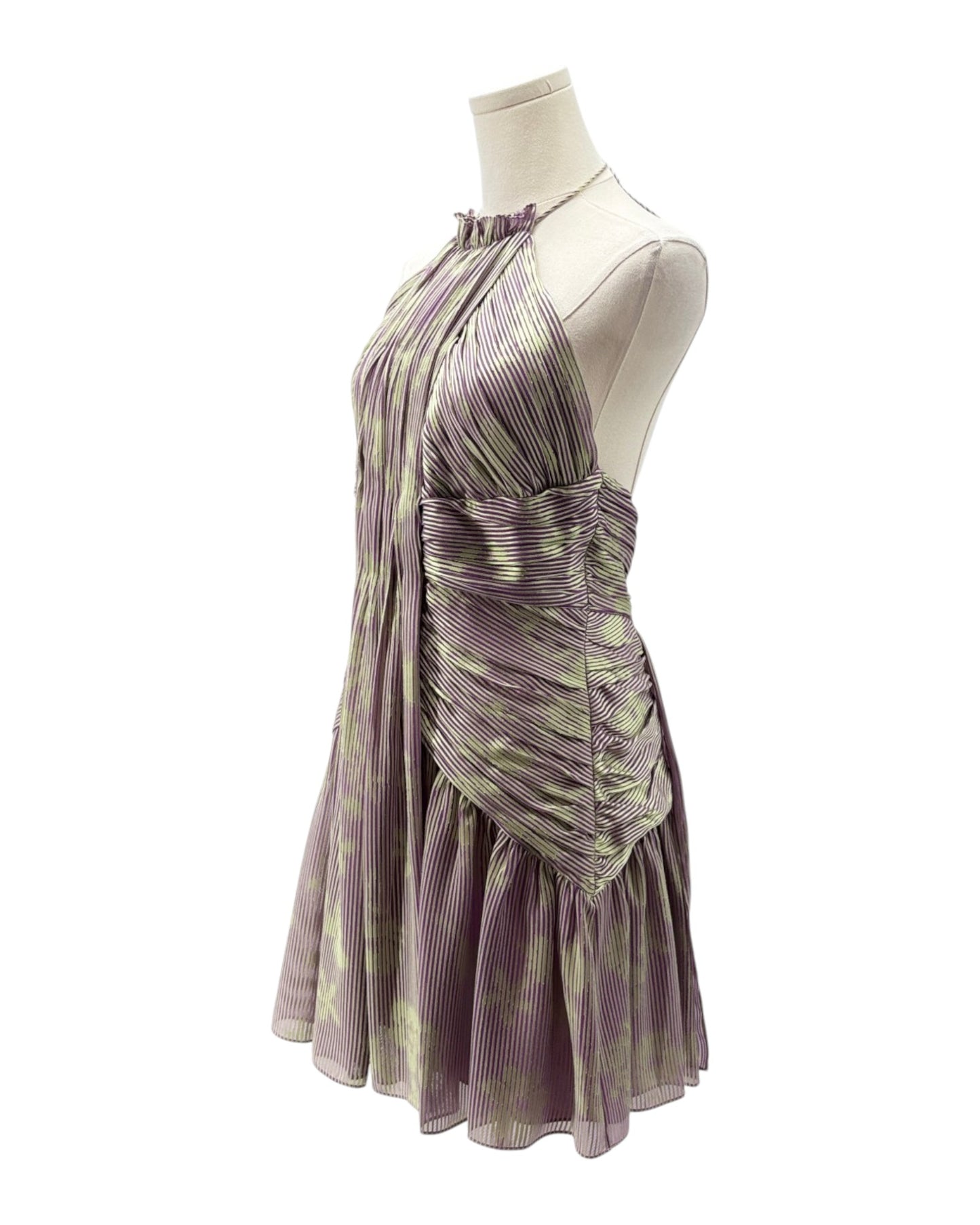 Purple and green pleated dress on a mannequin against a white background