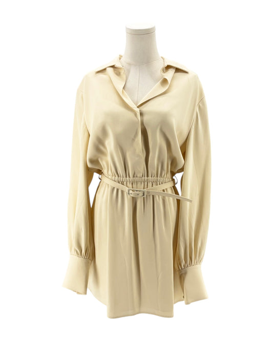 Beige dress on a mannequin against a white background