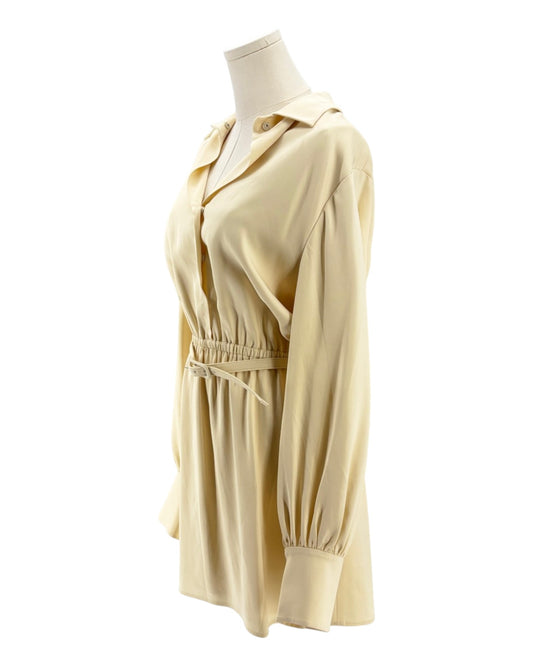 beige dress on a mannequin against a white background