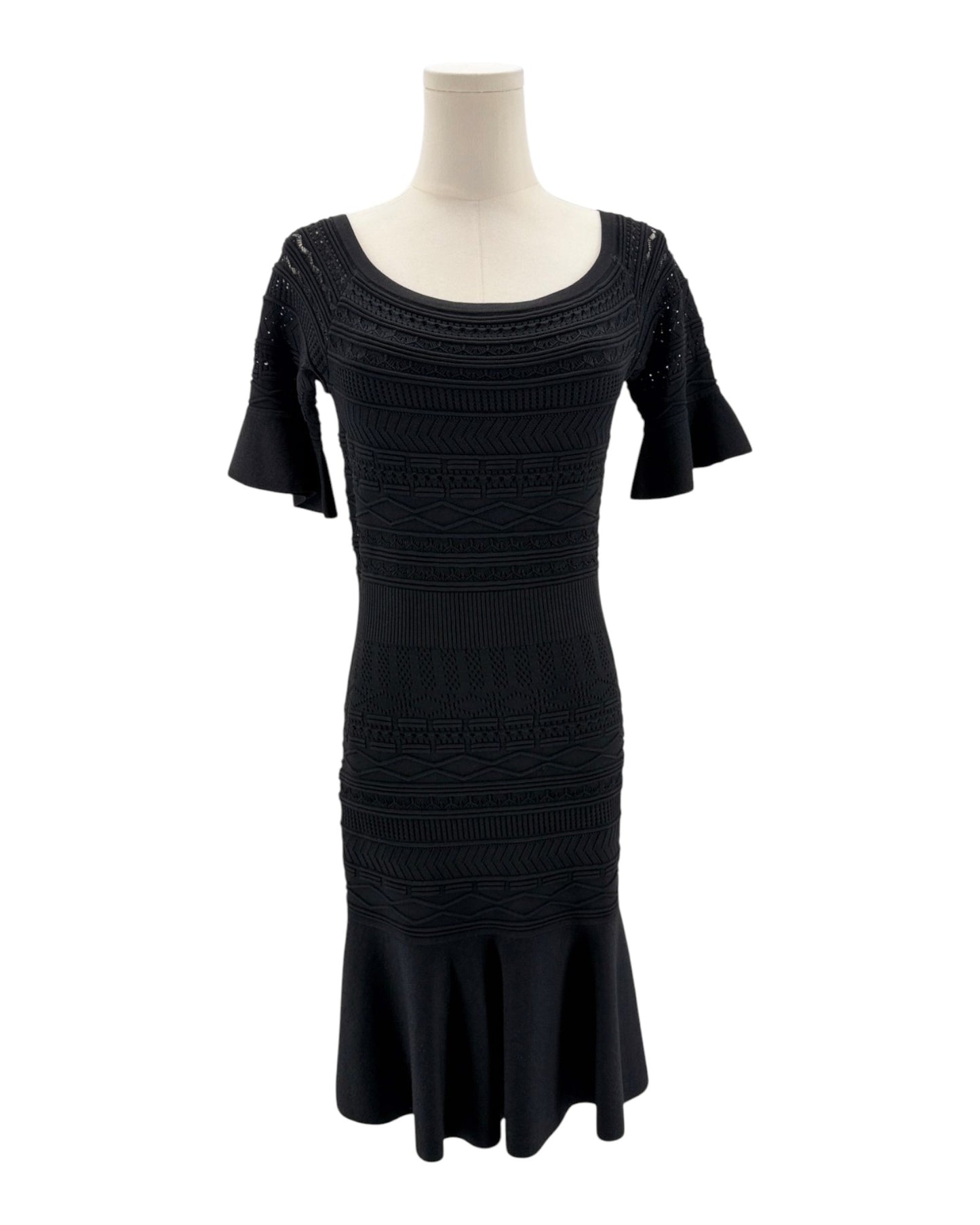 Black dress on a mannequin against a white background