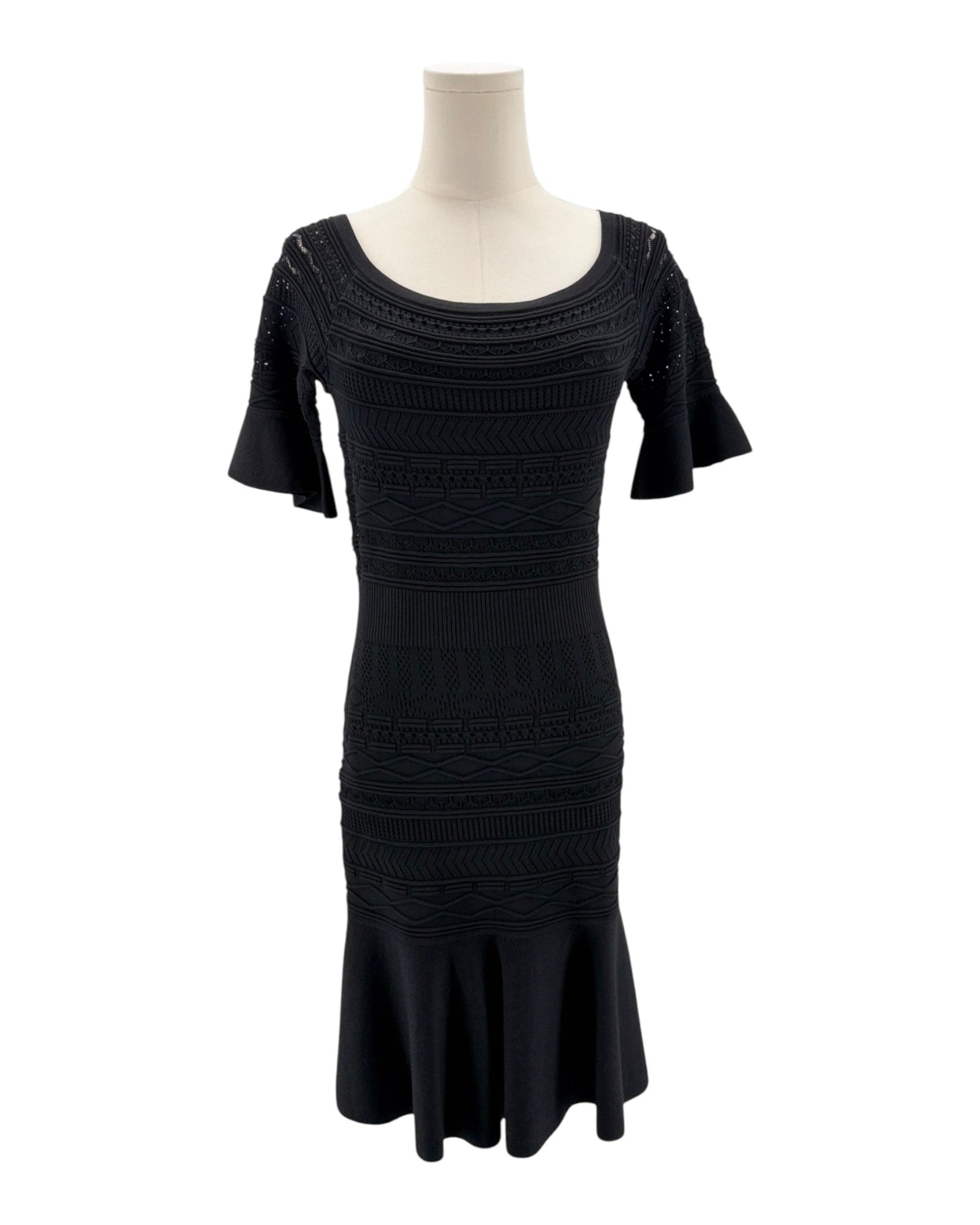Black dress on a mannequin against a white background