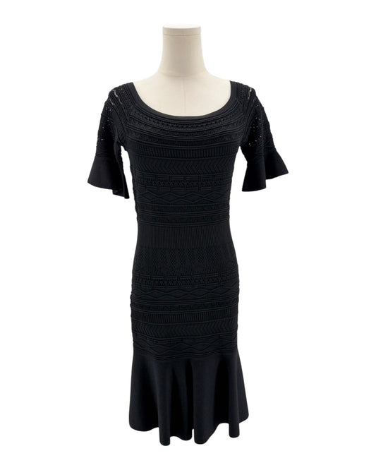 Black dress on a mannequin against a white background