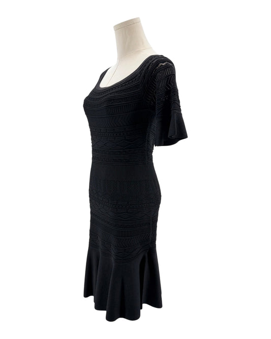 Black dress on a mannequin against a white background