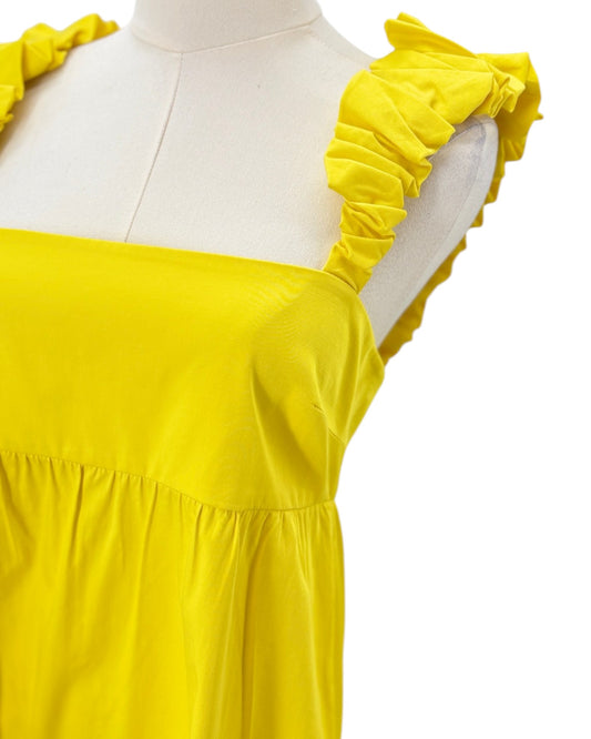 Alexis yellow dress with ruffled shoulders on a mannequin against a white background
